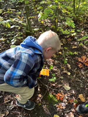 Boy explores at the school forest